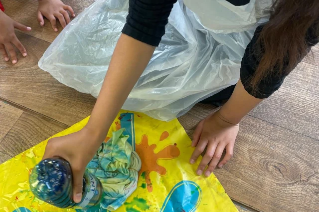 One of our children using slime on a t-shirt