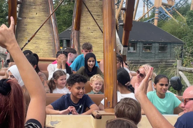 Our kids sat in a wooden ship-like ride at Flamingo Land 2024