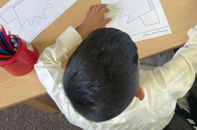 One of our happy children colouring in